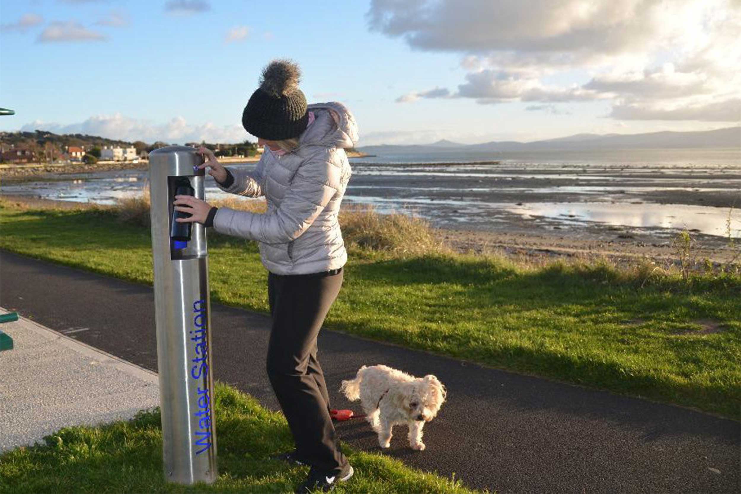 Water Station being used by a woman to refill water bottle